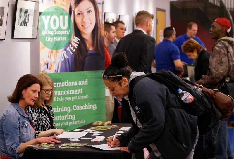 A job seeker fills out an application at the King Soopers grocery store table at a job fair at the Denver Workforce Center in Denver, Colo., on Feb. 15, 2017. (Rick Wilking/Reuters)