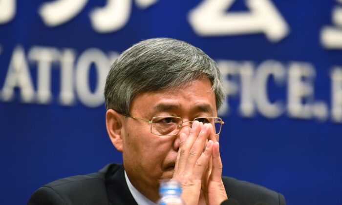 Guo Shuqing, Chairman of the China Banking Regulatory Commission, listens to a question during a press conference in Beijing on March 2, 2017. (Greg Baker/AFP/Getty Images)