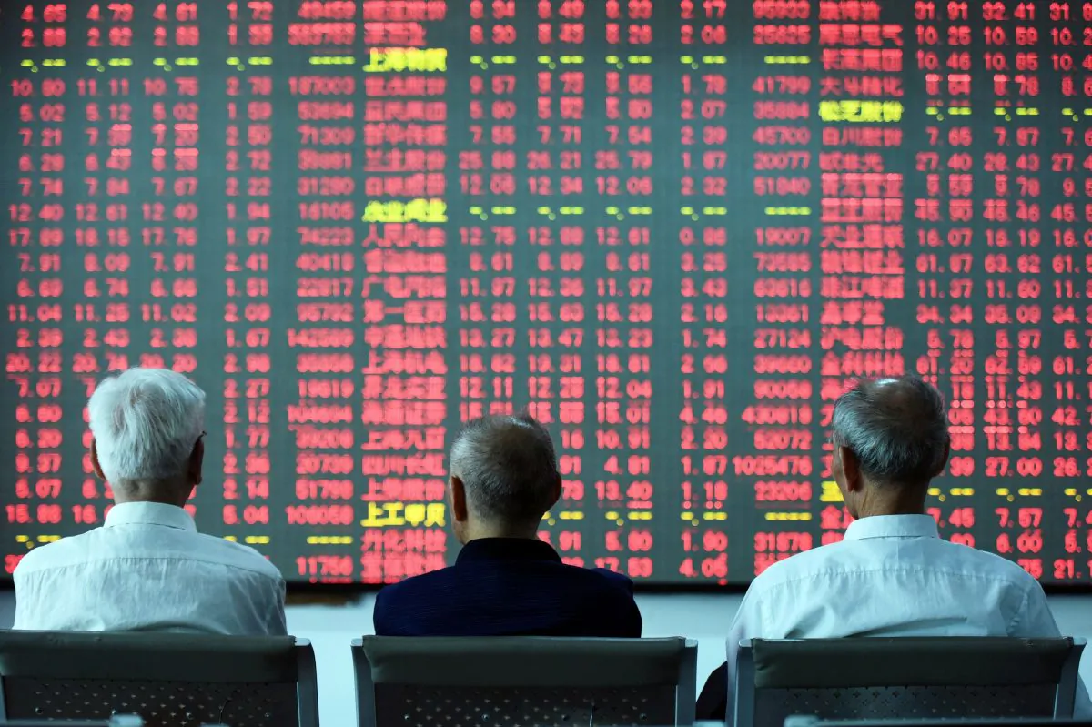 Chinese investors sit in front of a screen showing stock market movements at a securities firm in Hangzhou, China, on May 31, 2016. (STR/AFP/Getty Images)