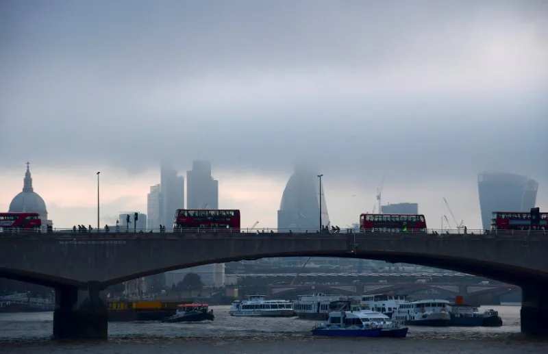 City workers cross the River Thames with the City of London financial district seen behind them, in Britain on Oct. 27, 2016. (REUTERS/Toby Melville)