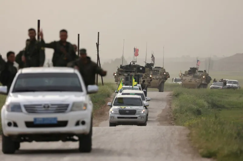 Kurdish fighters from the People's Protection Units (YPG) head a convoy of U.S.  military vehicles in the town of Darbasiya next to the Turkish border, Syria April 28, 2017. (Rodi Said/Reuters)