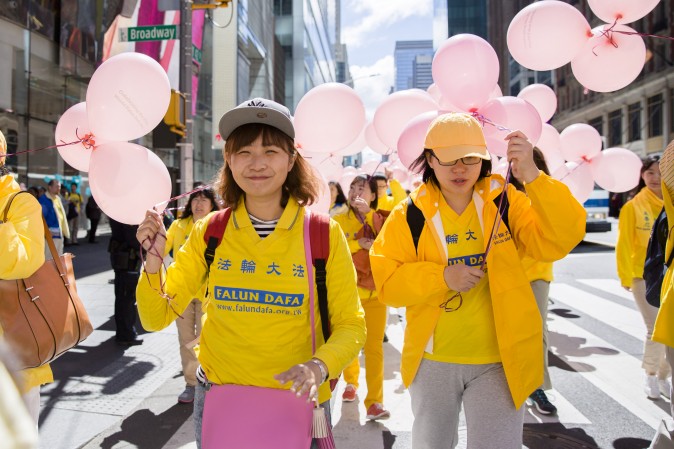 Thousands of Falun Gong practitioners march in a parade along 42nd Street in New York for World Falun Dafa Day on May 12, 2017. (Samira Bouaou/The Epoch Times/The Epoch Times)
