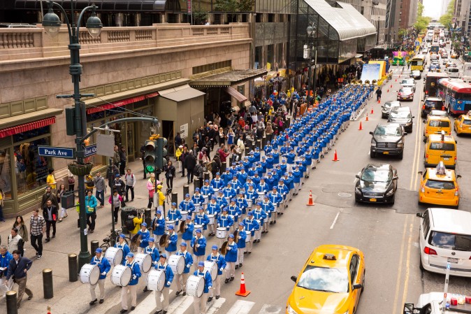 The Divine Land Marching Band marches in a parade along 42nd Street in New York for World Falun Dafa Day on May 12, 2017. (Evan Ningn/The Epoch Times)
