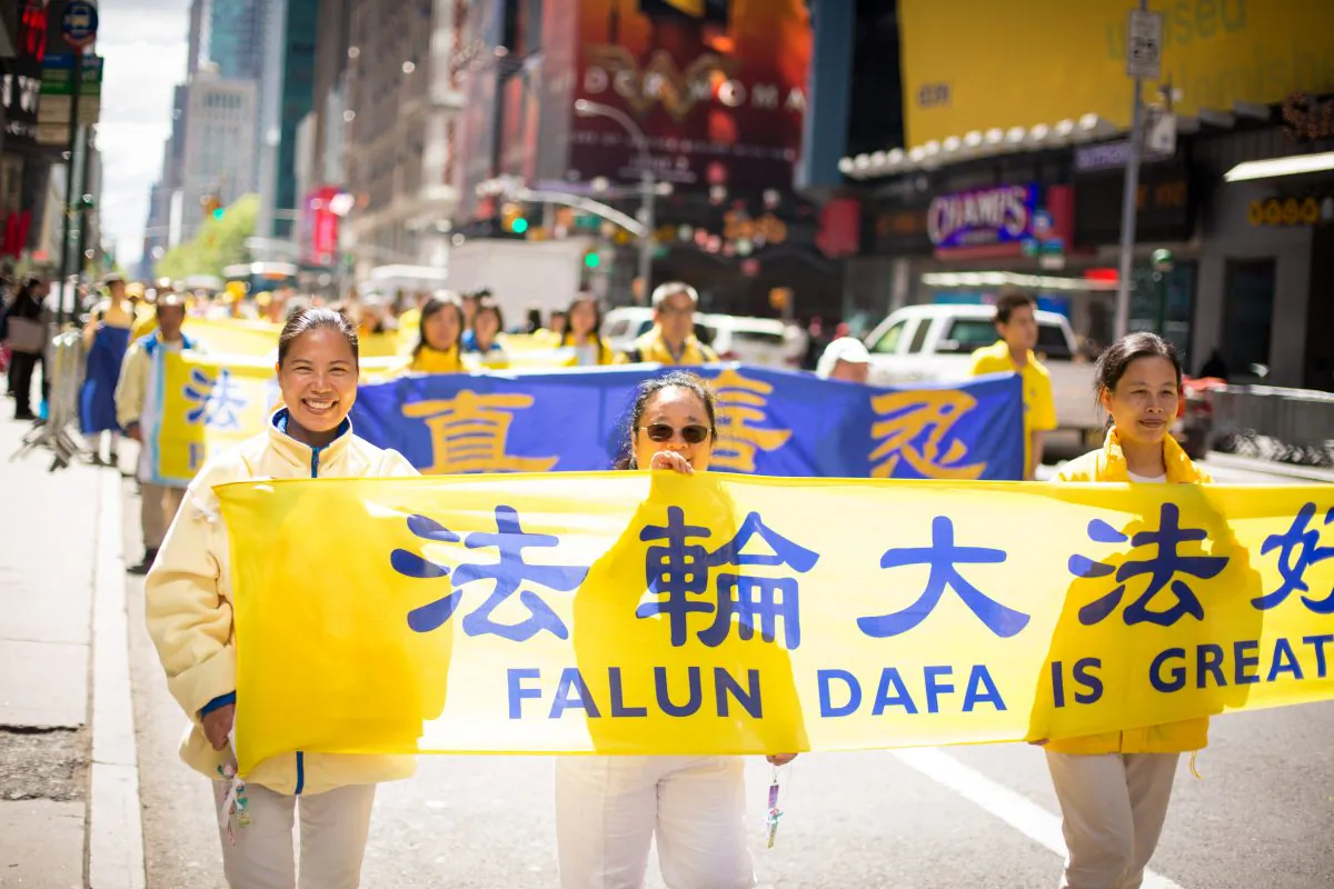 Thousands of Falun Gong practitioners march in a parade along 42nd Street in New York for World Falun Dafa Day on May 12, 2017. (Benjamin Chasteen/The Epoch Times)