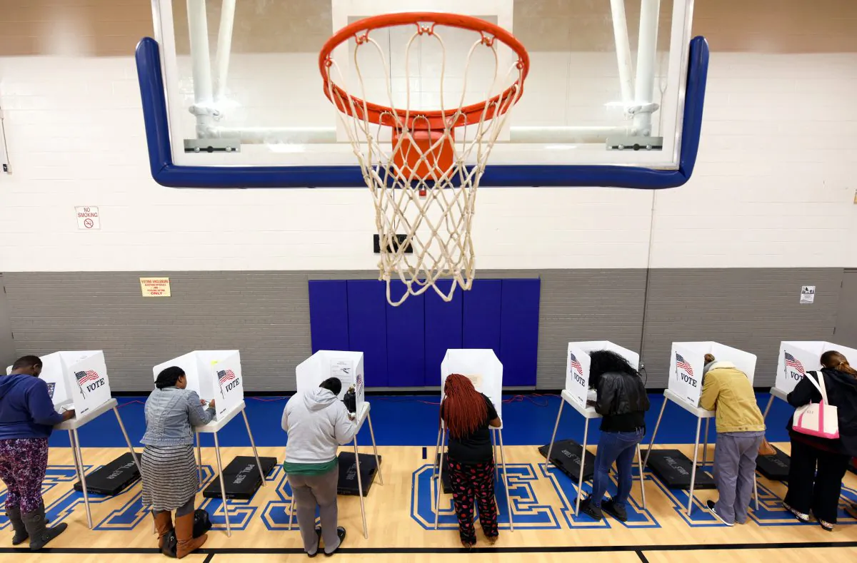 Citizens vote on a basketball court at a recreation center serving as polling place during the general election in Greenville, N.C., on Nov. 8, 2016. (REUTERS/Jonathan Drake)