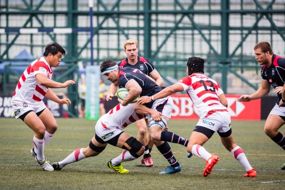 Hong Kong flanker Matt Lamming is covered by the Japanese defense. (Dan Marchant)