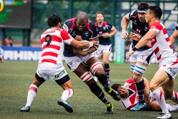 Hong Kong Lock Adrian Griffiths powers into the Japanese scrumhalf and captain Yukata Nagare. (Dan Marchant)
