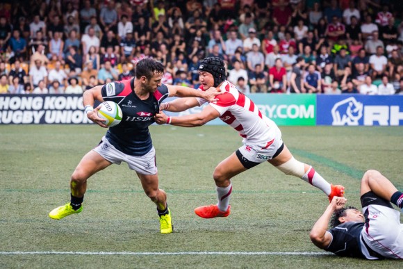 Hong Kong centre Tyler Spitz tries to shrug off his Japanese tackler. (Dan Marchant)