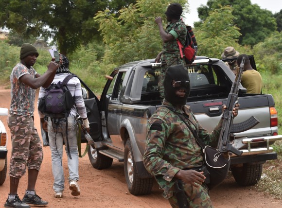 Mutinous soldiers gesture inside a military camp in the Ivory Coast's central second city Bouake, on May 15, 2017. Gunshots rang out early on May 15 in the Ivory Coast cities of Abidjan and Bouake amid a four-day-old mutiny by ex-rebel soldiers demanding government bonuses, AFP journalists and witnesses said. (Issouf Sanogo/AFP/Getty Images)