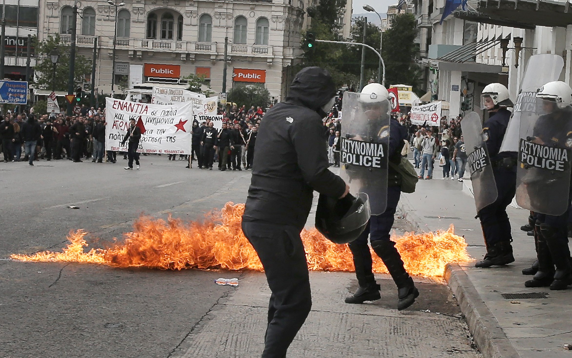 A demonstrator confronts riot police during a 24-hour general strike against the latest round of austerity in Athens, Greece on May 17, 2017. (REUTERS/Alkis Konstantinidis)