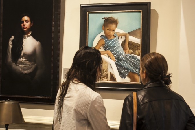 Two women look a the painting "Polka Dots," by Gregory Mortenson at the opening of the 12th International ARC Salon Exhibition at the Salmagundi Club in Manhatan, New York, on May 13, 2017. (Milene Fernandez/The Epoch Times)