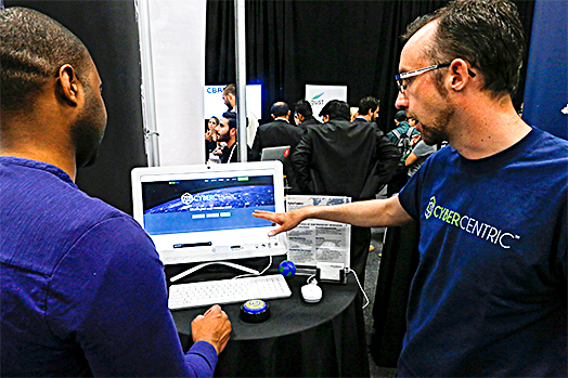 Weston Wheelehan (R) and Jeremiah Steptoe, CEO of CyberCentric, give a demonstration of their cybersecurity platform during the TechCrunch Disrupt event in New York on May 15. (REUTERS/EDUARDO MUNOZ)
