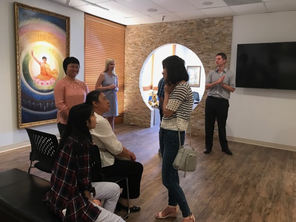 Patrons exploring the 20 paintings in the Art of Zhen Shan Ren Museum, in Tempe, Arizona. (Mel Etherton)