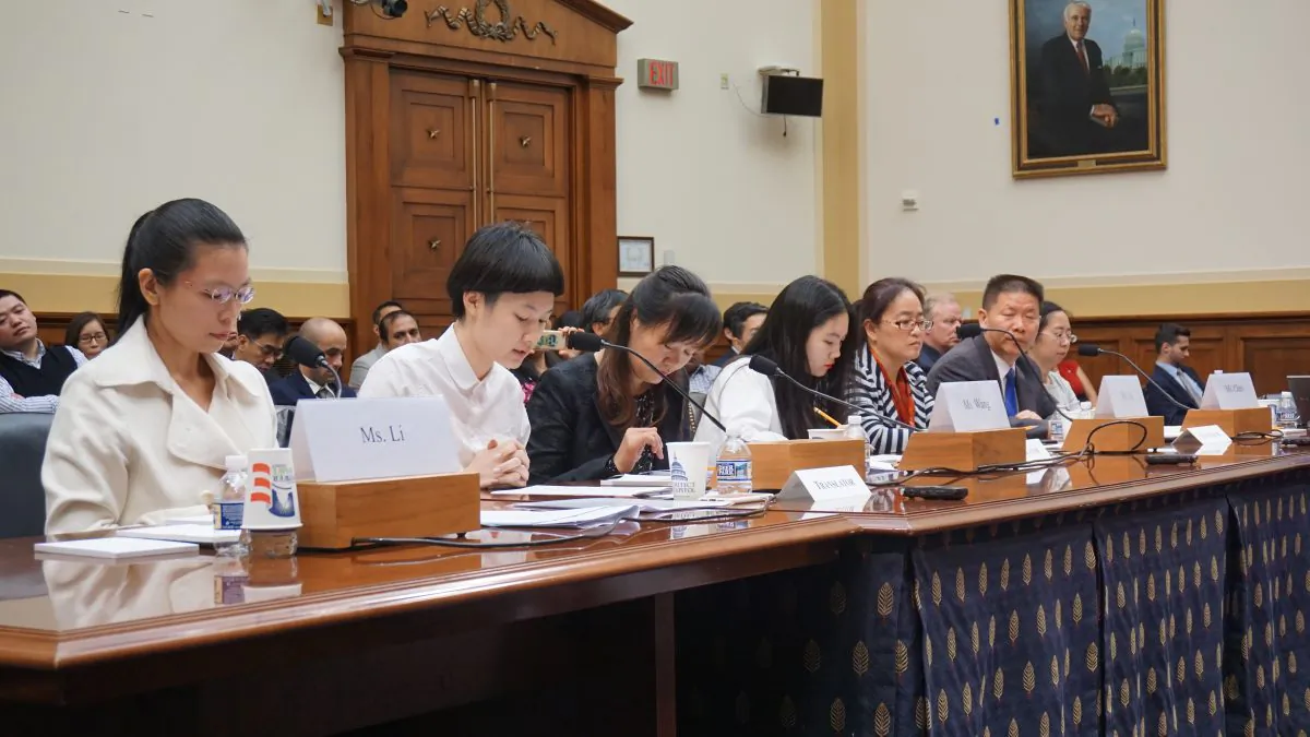 A panel consisting of four wives speaking on behalf of their husbands, detained in China for advocating for human rights, on May 18, in a hearing room on Capitol Hill. (L-R) Ms. Lee Chin-yu, wife of Lee Min-che; translator; Ms. Wang Yanfeng, wife of Tang Jingling; translator; Ms. Jin Bianling, wife of Jiang Tianyong; Bob Fu, president of China Aid; Ms. Chen Guiqiu, wife of Xie Yang. (Kitty Wang/NTD)