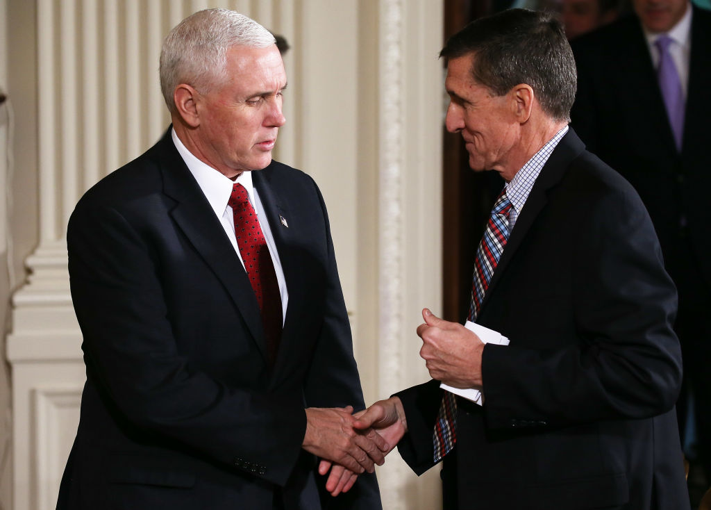 Vice President Mike Pence (L) shakes hands with then National Security Adviser Michael Flynn before President Donald Trump and Japanese Prime Minister Shinzo Abe hold a joint press conference at the White House in Washington on February 10, 2017. (Mario Tama/Getty Images)