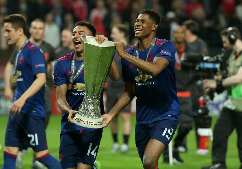 Manchester United's English striker Marcus Rashford (R) and Manchester United's English midfielder Jesse Lingard (2nd L) celebrate with the trophy after their team won the UEFA Europa League final football match Ajax Amsterdam v Manchester United on May 24, 2017 at the Friends Arena in Solna outside Stockholm. (Soren Andersson/AFP/Getty Images)