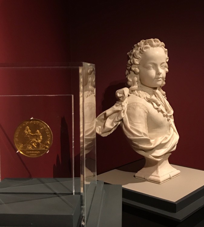 Antoine Coysevox (1640–1720), dated 1711, by Thomas Bernard (1650–1713). Gilt copper alloy, struck. Scher Collection, promised gift to The Frick Collection, and Louis XV as a Child of Six, 1716, by Antoine Coysevox (1640–1720). Marble, The Frick Collection, gift of Dr. and Mrs. Ira H. Kaufman, 1990. (Milene Fernandez/Epoch Times)
