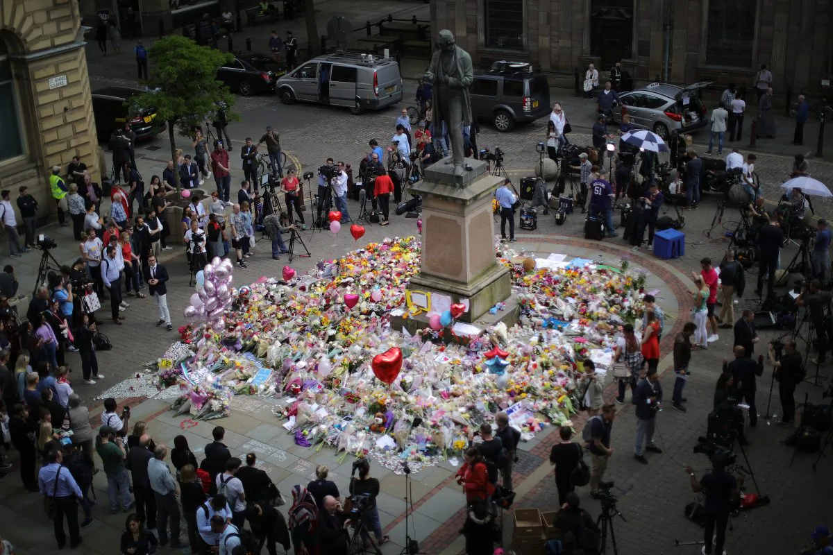 People gather around floral tributes to the victims of the Manchester terror attack ahead of a vigil in St. Ann's Square in Manchester, England, on May 24, 2017. (Christopher Furlong/Getty Images)