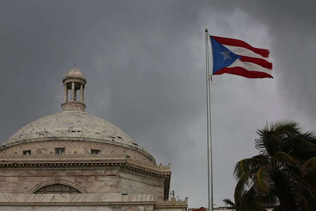 The Puerto Rican flag flies near the Capitol building as the island's residents deal with the government's $72 billion debt in San Juan, Puerto Rico, on July 1, 2015. (Joe Raedle/Getty Images)