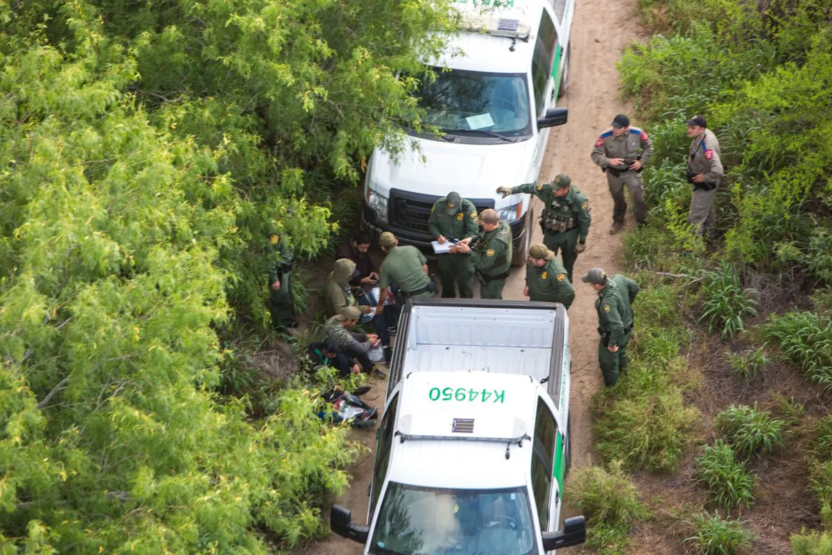 A view from a Border Patrol helicopter, shows the Texas Border Patrol and Texas State Troopers detaining illegal aliens from Mexico near McAllen, Texas, on May 30, 2017. (Benjamin Chasteen/The Epoch Times)