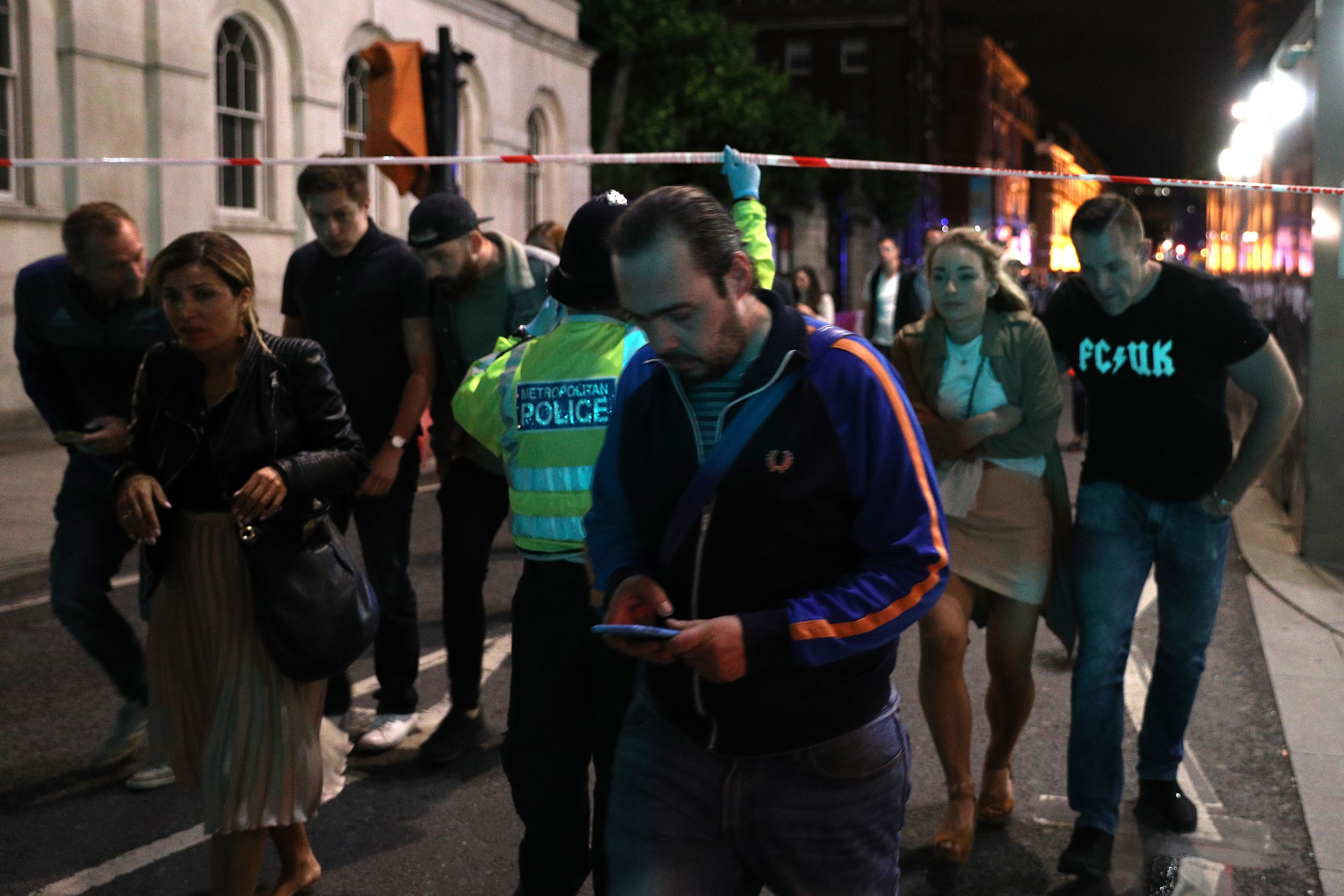 Police officers clear the area near Borough market at London Bridge in London, England on June 3, 2017. (Dan Kitwood/Getty Images)