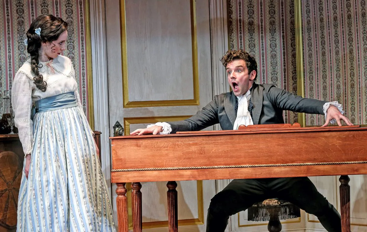 The mayor’s daughter (Talene Monahon) and Ivan Alexandreyevich Hlestekov (Michael Urie), who is assumed to be government official sent to spy on the town, in “The Government Inspector.” (Carol Rosegg) 
