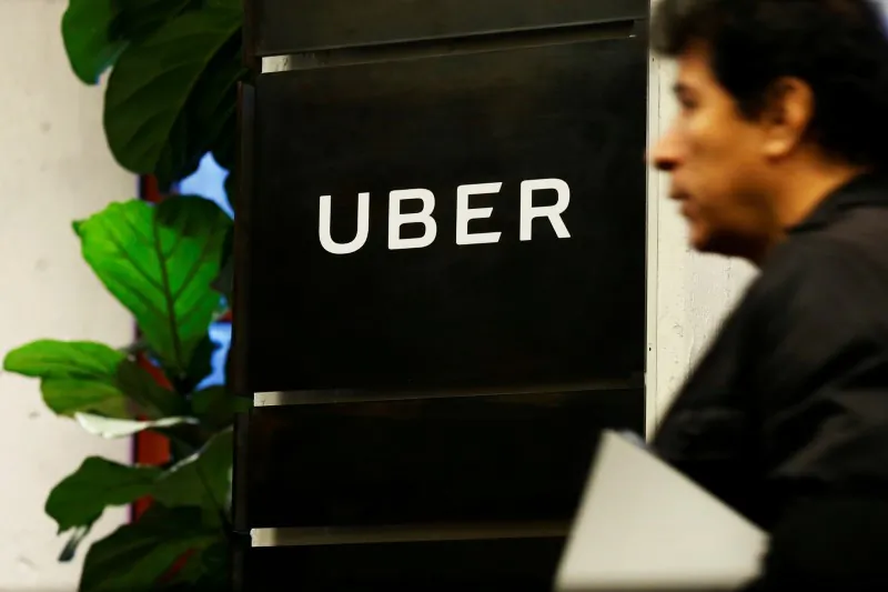 A man exits the Uber offices in Queens, New York on Feb. 2, 2017. (REUTERS/Brendan McDermid)
