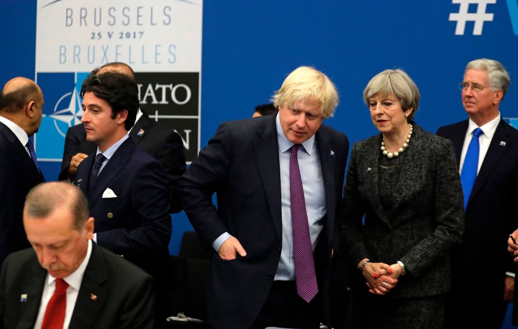 Britain's Prime Minister Theresa May (2-R) and Britain's Foreign Minister Boris Johnson (3-R) speak next to Turkish President Recep Tayyip Erdogan (L) during a working dinner meeting at the NATO (North Atlantic Treaty Organization) headquarters in Brussels on May 25, 2017. (MATT DUNHAM/AFP/Getty Images)