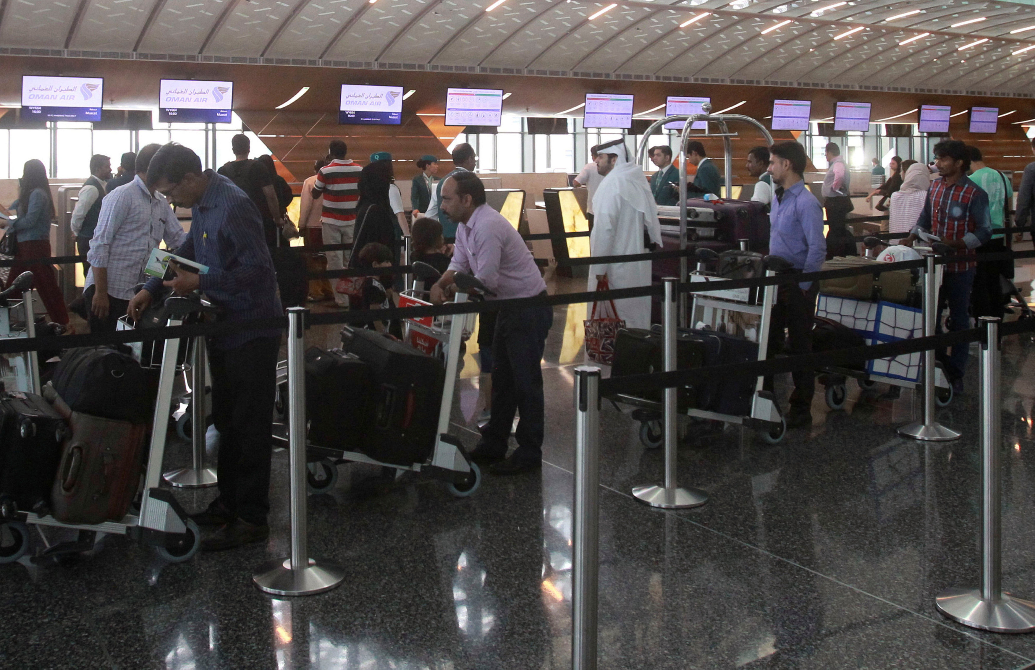 Passengers wait to have their luggage checked at Hamad International Airport in Doha, Qatar on June 7, 2017. (REUTERS/Naseem Zeitoon)