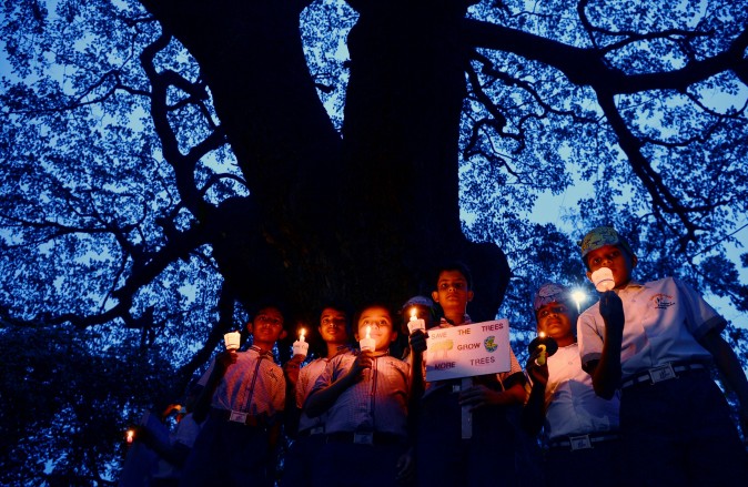Children participate at a candlelight vigil held as part of a 'Save Trees' awareness rally in Bangalore, India, on June 7, 2017. (MANJUNATH KIRAN/AFP/Getty Images)