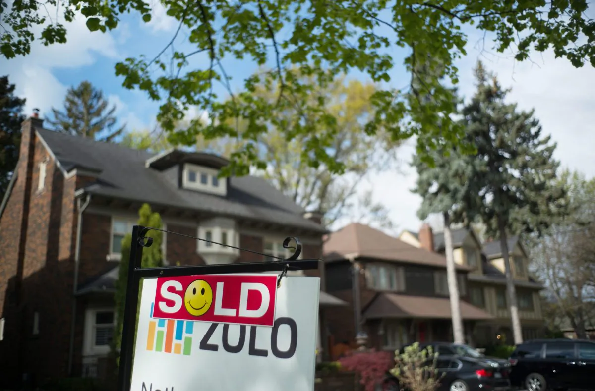 A sold sign in front of a west-end Toronto home on May 14, 2017. Sales and prices are down while listings are way up in the latest report from the Toronto Real Estate Board. (The Canadian Press/Graeme Roy)