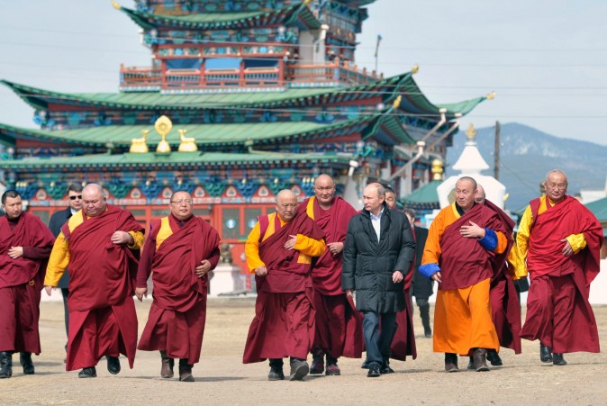 Russian President Vladimir Putin (3rdR) walks with Buddhist monks as he visits Ivolginsky Datsan (monastery) in the village of Verkhnyaya Ivolga, Republic of Buryatia on April 11, 2013. (ALEKSEY NIKOLSKYI/AFP/Getty Images)