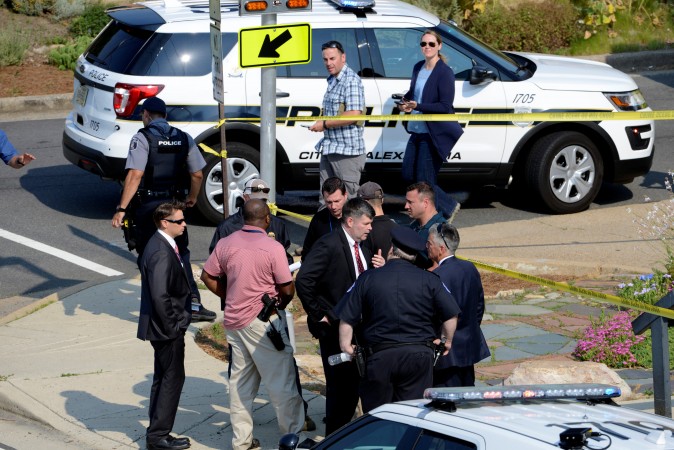 Police and investigators gather at an intersection near the scene where shots were fired during a congressional baseball practice, wounding House Majority Whip Steve Scalise (R-LA), in Alexandria, Virginia on June 14, 2017. (REUTERS/Mike Theiler)
