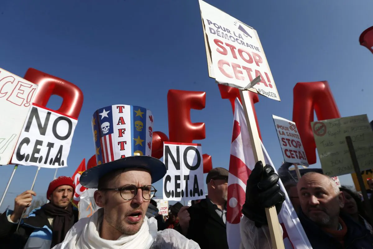 Demonstrators march against the CETA trade deal near the European Parliament in Strasbourg, France on Feb.15, 2017. Globalization has not been kind to incomes of most of the middle class in developed world economies. (AP Photo/Jean-Francois Badias)