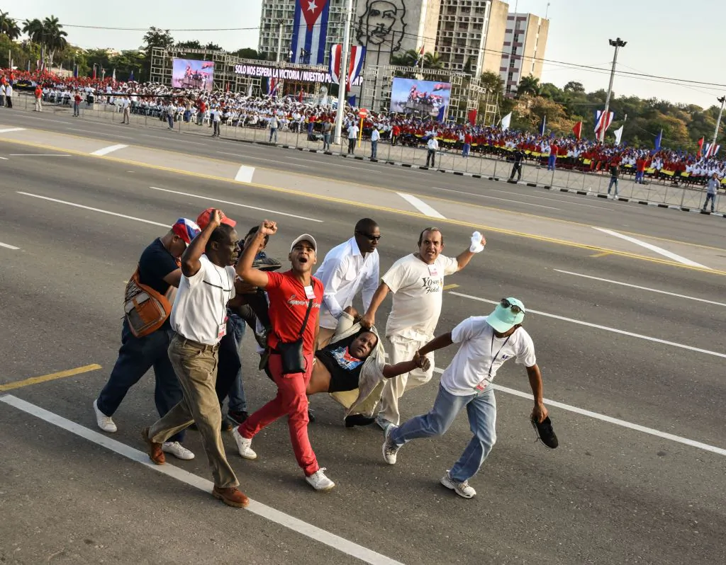 A man who burst in of the May Day march waving a US flag is taken away, at Revolution Square in Havana, on May 1, 2017. (ADALBERTO ROQUE/AFP/Getty Images)