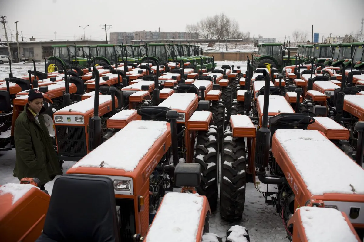 A farmer looks at tractors at a farm machine factory on February 21, 2009 in Changchun, Jilin Province, China. (China Photos/Getty Images)