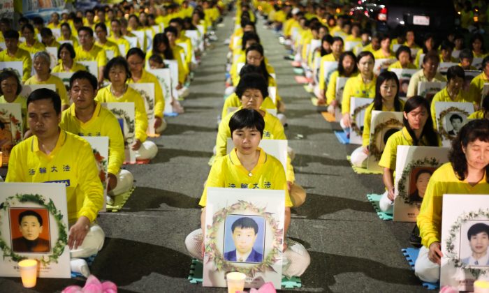 Falun Gong practitioners hold a candlelight vigil in front of the Chinese Consulate in Los Angeles on Oct. 15, 2105, for those who have died during the 16 year persecution in China. They demand that Jiang Zemin be brought to justice. (Benjamin Chasteen/Epoch Times)