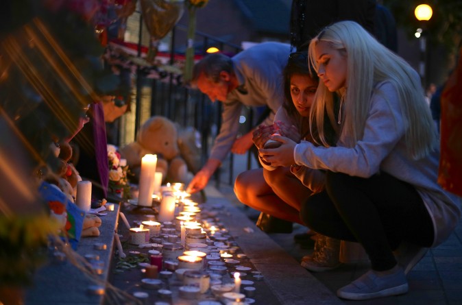 People light candles for a memorial outside Notting hill Methodist Church following the blaze at Grenfell Tower, a residential tower block in west London on June 15. (DANIEL LEAL-OLIVAS/AFP/Getty Images)