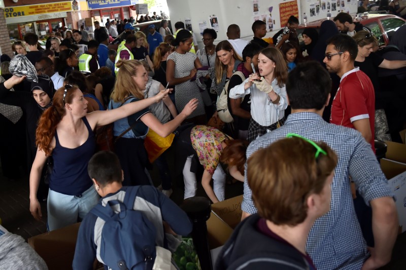 Volunteers help organise supplies following the fire that destroyed the Grenfell Tower block, in north Kensington, West London, Britain on June 16, 2017. (REUTERS/Hannah McKay)