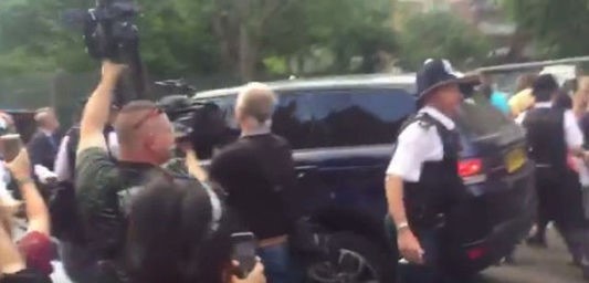 British Prime Minister Theresa May is barracked while she is bundled into her car, as she visits an emergency centre close to the scene of the Grenfell Tower fire, in north Kensington, West London, Britain, in this picture filmed by 5 News producer Rachel Lucas and obtained on June 16, 2017 on social media. (Social media via REUTERS/Courtesy ÒRACHEL LUCAS / 5 NEWSÓ)