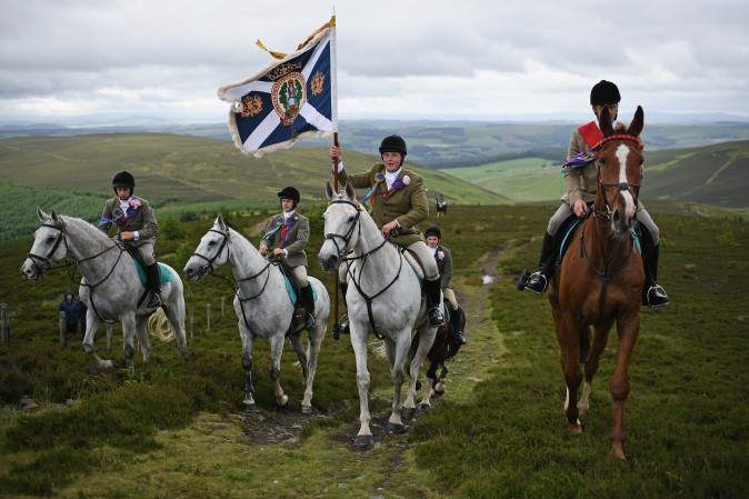 Standard bearer Kieran Riddell and his attendants arrive at The Three Brethren as they take part in the Common Riding, one of the oldest Borders festivals in Selkirk, Scotland, on June 16, 2017. The event dating from the Battle of Flodden in 1513, remembers the story when the town of Selkirk sent 80 men into battle with the Scottish king. One man returned, bearing a blood-stained English flag. (Jeff J. Mitchell/Getty Images)