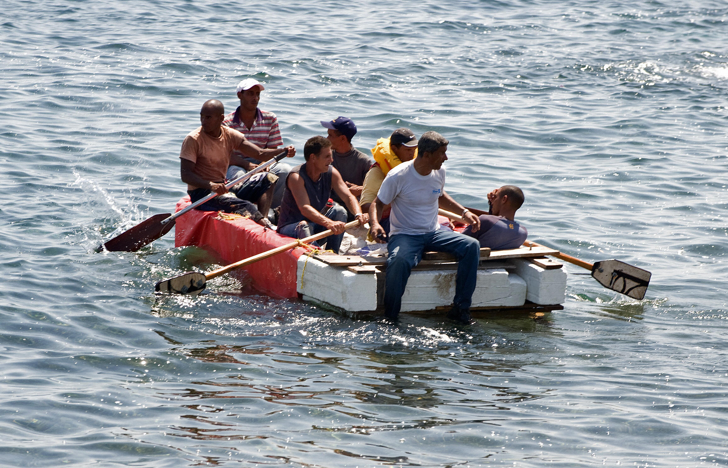 Seven would-be Cuban emigres remain in a homemade boat moments before being arrested by Cuban military agents after their attempt to escape from the island nation was thwarted by the sea currents, on June 4, 2009 in Havana. (Adalberto Roque/AFP/Getty Images)