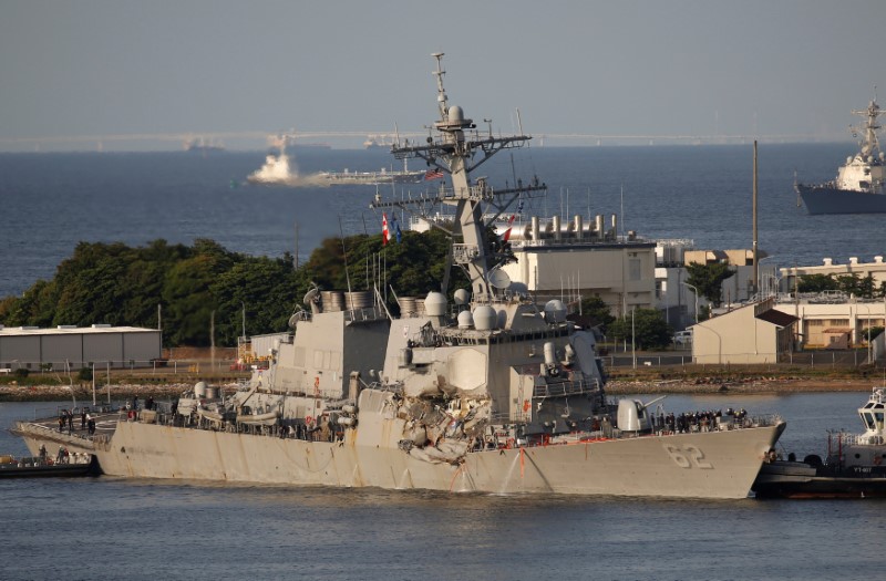 The Arleigh Burke-class guided-missile destroyer USS Fitzgerald, damaged by colliding with a Philippine-flagged merchant vessel, is towed by a tugboat upon its arrival at the U.S. naval base in Yokosuka, south of Tokyo, Japan June 17, 2017. REUTERS/Toru Hanai