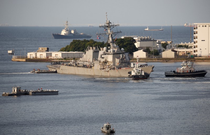 The Arleigh Burke-class guided-missile destroyer USS Fitzgerald, damaged by colliding with a Philippine-flagged merchant vessel, is towed by a tugboat upon its arrival at the U.S. naval base in Yokosuka, south of Tokyo, Japan June 17, 2017. REUTERS/Toru Hanai
