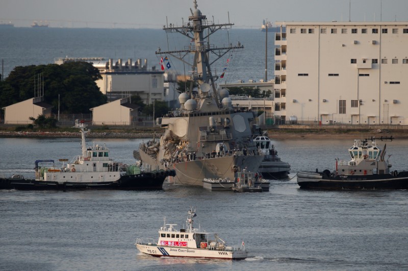 The Arleigh Burke-class guided-missile destroyer USS Fitzgerald, damaged by colliding with a Philippine-flagged merchant vessel, is towed by tugboats upon its arrival at the U.S. naval base in Yokosuka, south of Tokyo, Japan June 17, 2017. REUTERS/Toru Hanai