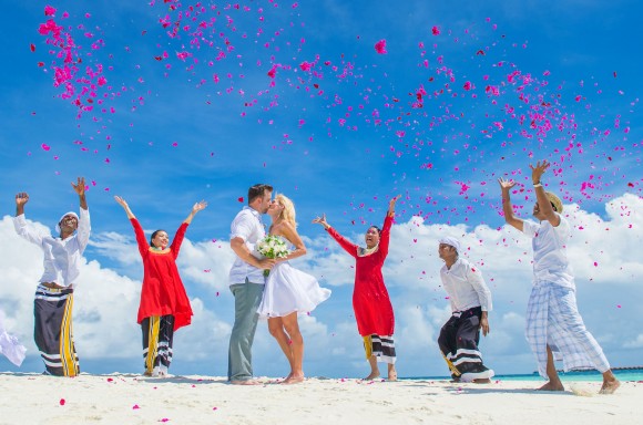 The happy couple share a kiss after their wedding. (Muha Photos)