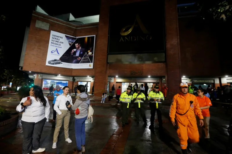 People, police officers and rescue personnel stand outside the Andino shopping center after an explosive device detonated in a restroom, in Bogota, Colombia June 17, 2017. (Reuters/Jaime Saldarriaga)