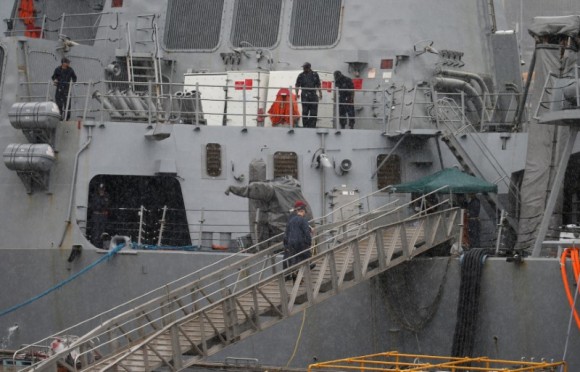 Personnel are seen on the Arleigh Burke-class guided-missile destroyer USS Fitzgerald which has been damaged by colliding with a Philippine-flagged merchant vessel, at the U.S. naval base in Yokosuka, Japan, June 18, 2017. (Reuters/Toru Hanai)