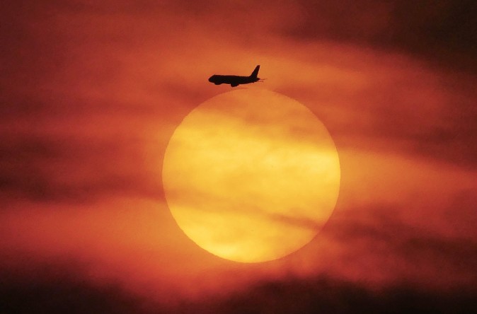A plane flies during sunset near Jakarta, Indonesia, on June 18, 2017. (BAY ISMOYO/AFP/Getty Images) 