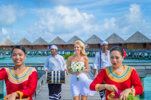 The bride walks to meet the groom before the wedding ceremony. (Muha Photos)